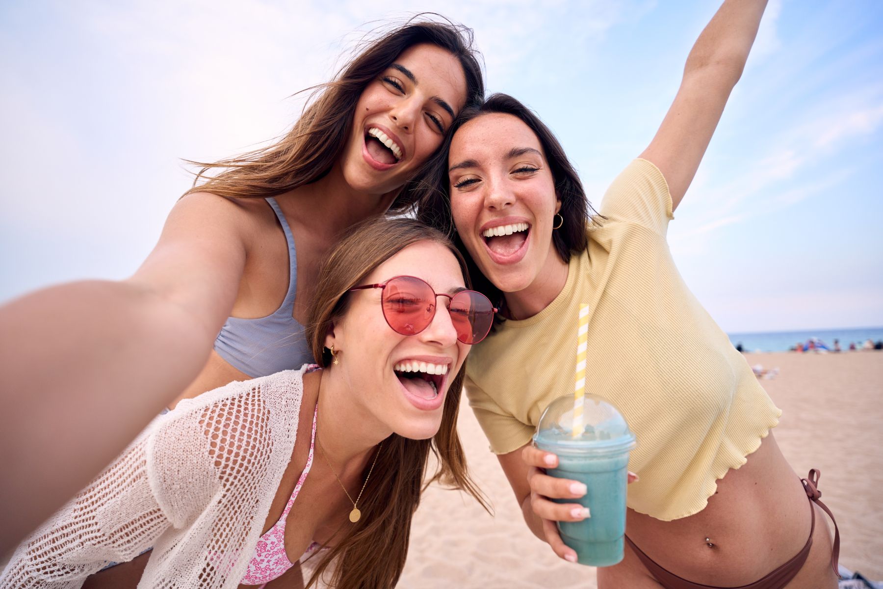 Young women taking a group picture on the beach